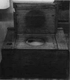 This wooden box encloses a square water closet from early American days.